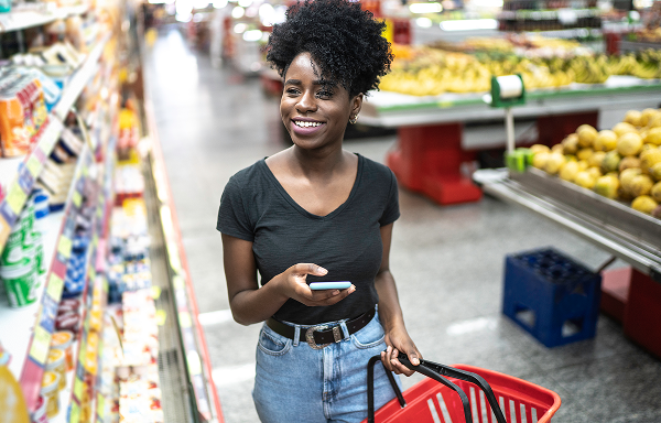 Lady shopping and holding her phone in a store.